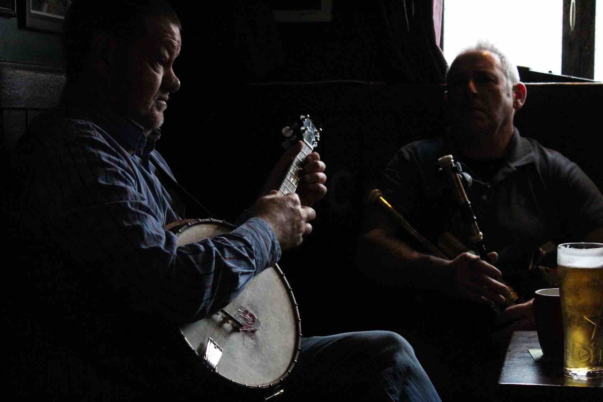 Image of two musicians in a pub